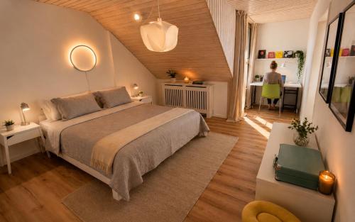 a bedroom with a bed and a woman in a room at Maisonette Wohnung WALDLOFT in Mehlmeisel