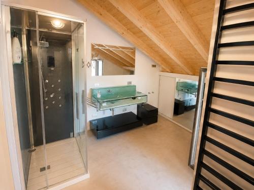 a room with a pool table and a glass shower at Mansarda Boutique May in Bergamo