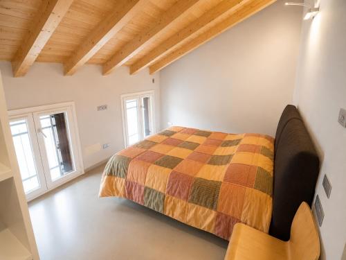 a bedroom with a bed in a room with wooden ceilings at Mansarda Boutique May in Bergamo