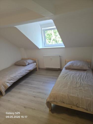 a bedroom with two beds and a window at Malamin Ludwigshafen in Ludwigshafen am Rhein