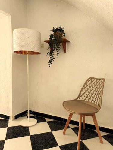 a chair and a lamp in a room at Casa Mirador in Loja