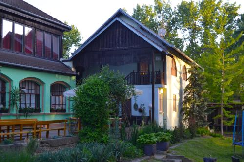 an old house with a green and black building at Čarda Ranč in Berava