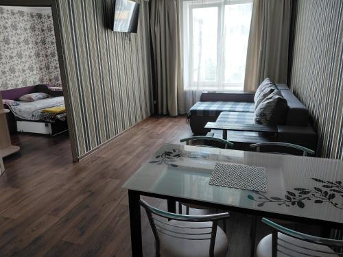 a living room with a table and a couch at ЖК Хмельницький in Dnipro