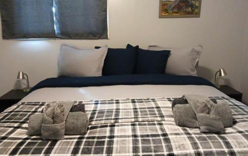 a bed with two pairs of shoes on it at Sword and Dove Rental in Spirit River