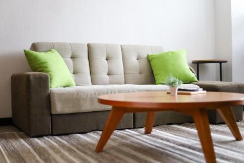 a living room with a couch and a coffee table at Desroches House in Kanazawa