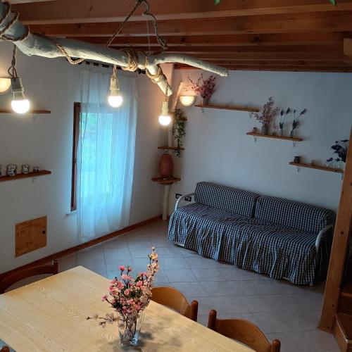 a living room with a table and a couch at La Casa del Zuf in Carlino