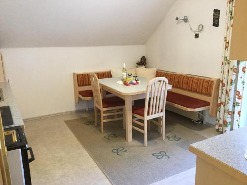 a kitchen with a table and chairs and a couch at Ferienhaus Andrä in Hermagor