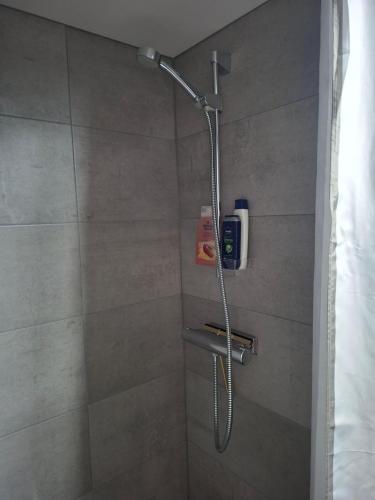 a shower with a shower head in a bathroom at Boende i Falkenberg in Falkenberg