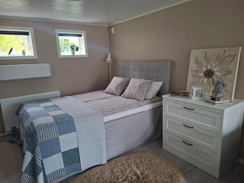a small bedroom with a bed and a dresser at Boende i Falkenberg in Falkenberg