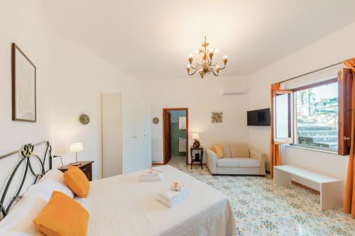 a bedroom with a bed and a living room at Casa degli Ulivi in Ravello