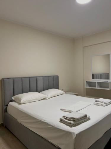 a bedroom with a large white bed with towels on it at Floor Villa 2 in Vlorë
