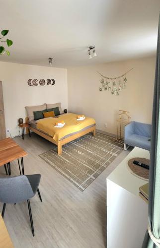 a bedroom with a bed and a couch in it at Downtown Boho Botanico in Brno