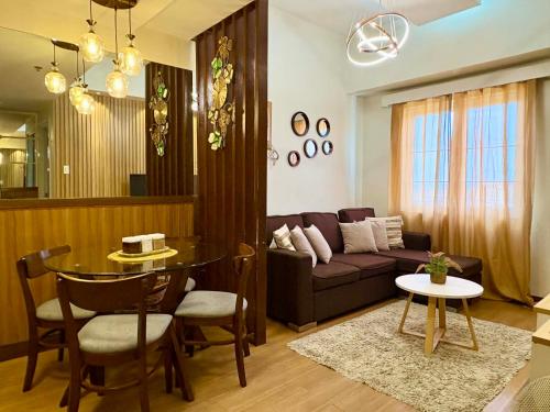 a living room with a couch and a table at Aesthetic 2 Bedroom The Loop Tower Condo Unit in Cagayan de Oro