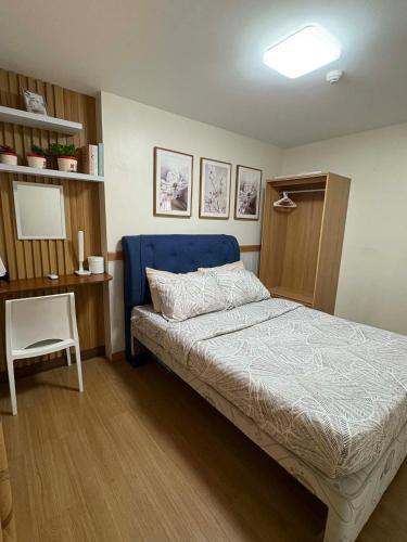 a bedroom with a bed and a desk with a chair at Aesthetic 2 Bedroom The Loop Tower Condo Unit in Cagayan de Oro