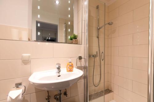 a bathroom with a sink and a shower at Top gelegene Ferienwohnung mit Balkon direkt im Zentrum von SPO in Böhl
