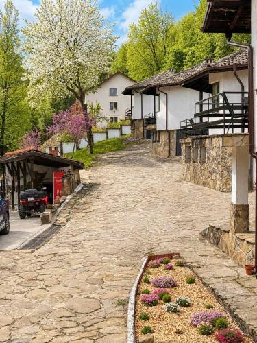a cobblestone street with flowers in a garden at Комплекс Света Гора in Oreshak
