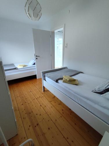a bedroom with a bed and a wooden floor at Apartments Justin in Bled