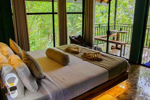 a bedroom with a bed with pillows on it at Nice View Guest House & Restaurant in Ella