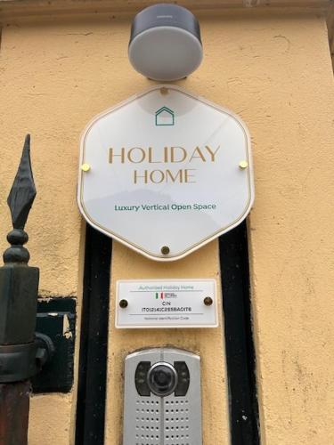 a sign for a holiday home with a camera at LUXURY vertical open space in Sangiano