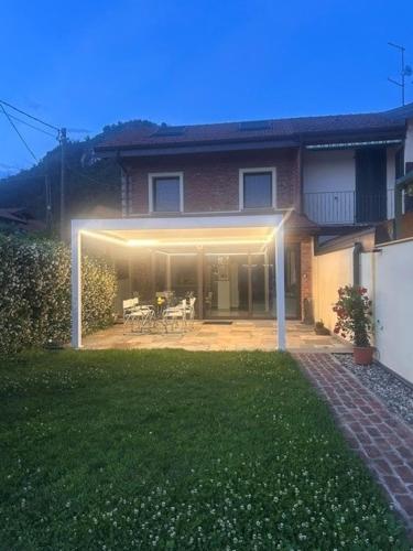 a house with a patio with a table and chairs at LUXURY vertical open space in Sangiano