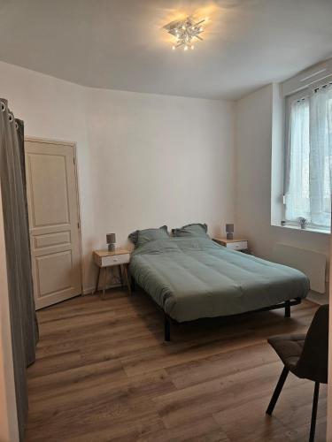 a bedroom with a bed and two tables in it at 3-room apartment 2b in Thionville