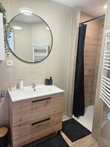 a bathroom with a sink and a mirror at 3-room apartment 2b in Thionville