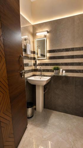 a bathroom with a sink and a mirror at Hotel Himalayan Heaven - A Most Luxury & Best Mountain View Hotel In Mussoorie By lilly in Mussoorie