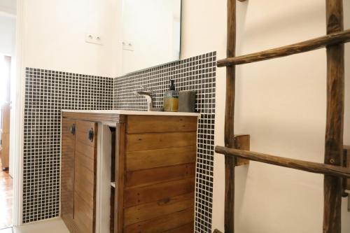 a bathroom with a sink and a wooden cabinet at AL Penedo da Cheira in Penacova