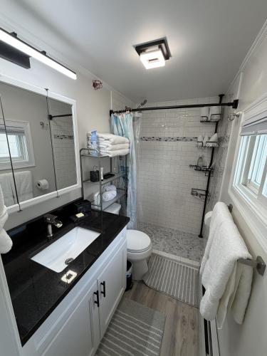 a bathroom with a sink and a toilet and a shower at Salty & Sweet 303 in Old Orchard Beach