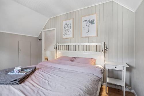 a bedroom with a large bed and a table at The Reine Scenic View in Moskenes