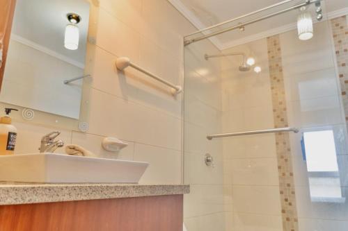a bathroom with a sink and a shower at Puerto Santa Ana, river view 102 in Guayaquil