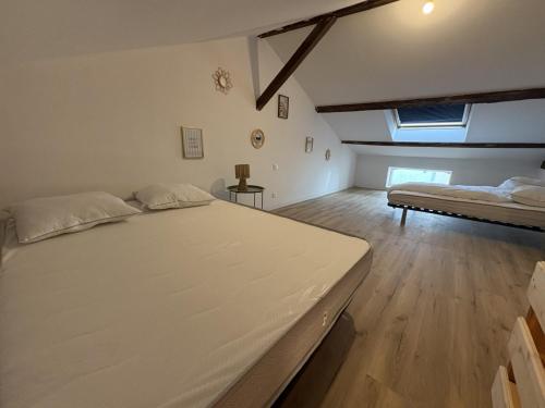 a bedroom with two beds in a room at LONI Expériences moderne emplacement idéal in Challans