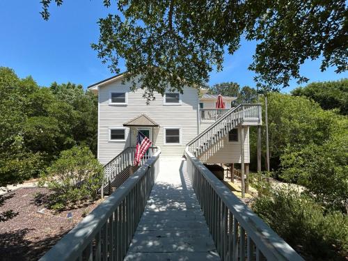 a house on a bridge with an american flag at 3BR 3BA Beach House in Kitty Hawk Beach
