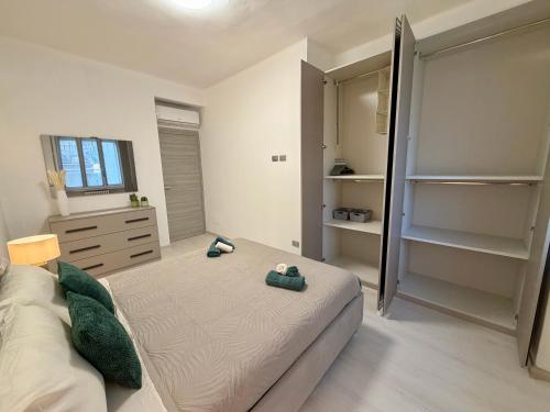 a bedroom with a bed and a dresser and a mirror at Wake to Lake - Arona, Lago Maggiore in Arona