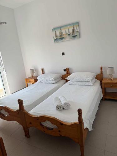 a bedroom with two beds with towels on them at Zografos 5 in Haraki