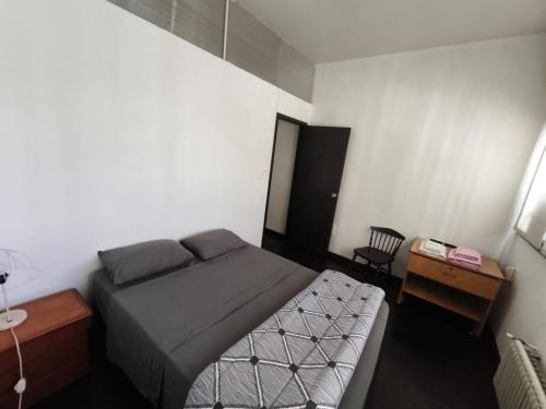 a small bedroom with a bed and a desk at Libertador 2 in Montevideo