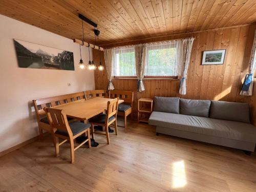 a living room with a table and a couch at Haus Mader 3 in Riscone