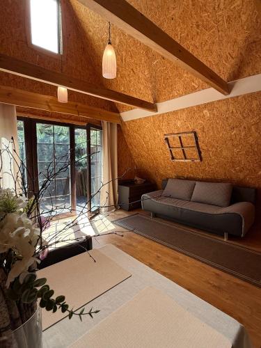a living room with a couch and a table at Domki Brzozowy Zakątek in Sochy