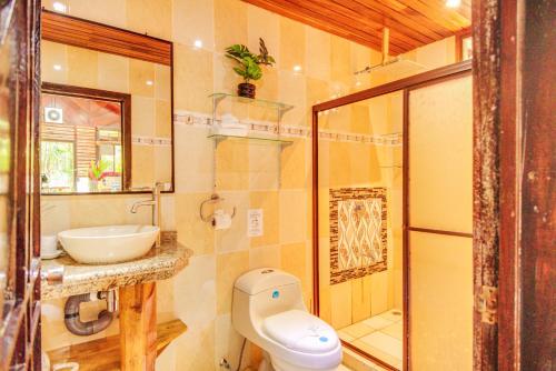 a bathroom with a toilet and a sink and a shower at Casa Shaquir H -Luxury Villa with Private Pool & Stunning Views in Puerto Viejo