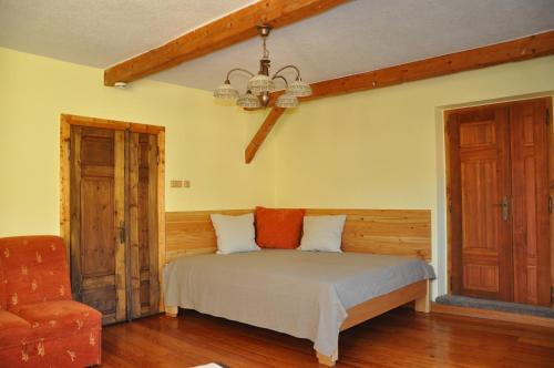 a bedroom with a bed and a chandelier at Apartmán Kamenný Dům in Jilemnice