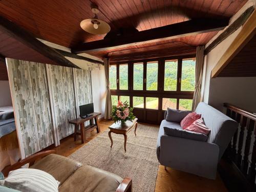 a living room with a couch and a table at Casa Mayucu in Celis