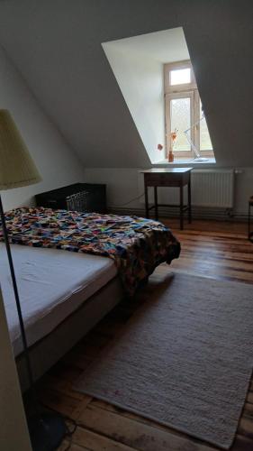 a bedroom with a bed and a window and a table at Krusenhofilona in Krusendorf