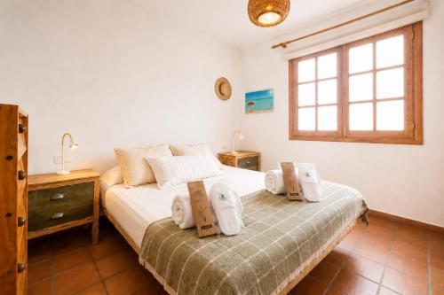 a bedroom with a bed with towels on it at Deluxe Mogán Beach Apt 1 in Puerto de Mogán