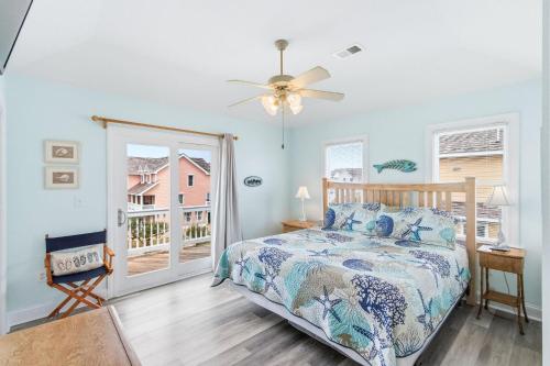 a bedroom with a bed and a window at Beach Nutz in Nags Head