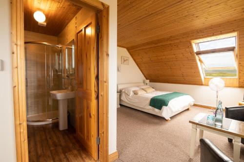 a bedroom with a bed and a sink in a room at Pier House in Doolin