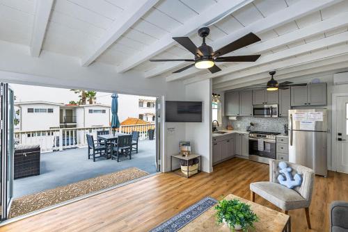 a kitchen and living room with a ceiling fan at Steps to the pier! in San Clemente