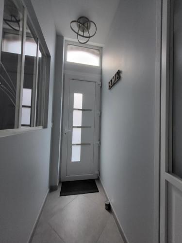 a hallway with a door and a sign that reads exit at Loéli's House in Tourcoing