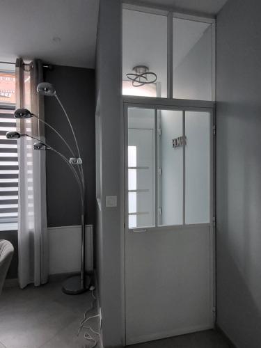 a shower in a room with a glass door at Loéli's House in Tourcoing
