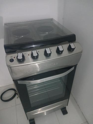 a stove top oven sitting in a kitchen at Blue Song Villa in Braco