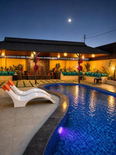 a swimming pool with a white object in front of a building at WesamFarm in Amman